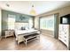 Serene main bedroom with a king-size bed, wood floors, and ample natural light at 16413 Rivers Reach Blvd, Parrish, FL 34219