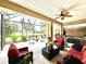 Outdoor screened patio featuring ceiling fan and seating arrangement at 16413 Rivers Reach Blvd, Parrish, FL 34219