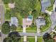 Aerial view of a home showcasing a backyard pool, mature trees, and proximity to neighborhood streets at 18504 Putters Pl, Tampa, FL 33647