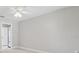 Neutral bedroom with light wood floors, modern ceiling fan and ensuite bathroom at 18504 Putters Pl, Tampa, FL 33647