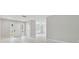 Bright entryway with white door, sidelights, and light wood floors leads into a spacious living area at 18504 Putters Pl, Tampa, FL 33647