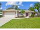 Charming single-story home with a well-manicured lawn and a two-car garage at 18504 Putters Pl, Tampa, FL 33647