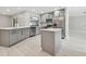 Modern kitchen with gray cabinets, stainless appliances, and a central island at 18504 Putters Pl, Tampa, FL 33647