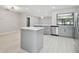 Modern kitchen with gray cabinets, stainless appliances, and a kitchen island at 18504 Putters Pl, Tampa, FL 33647