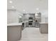 Modern kitchen with gray cabinets, stainless appliances, and an island at 18504 Putters Pl, Tampa, FL 33647