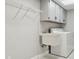 Laundry room with overhead cabinets, sink, and washing machine at 18504 Putters Pl, Tampa, FL 33647