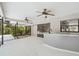 A spacious outdoor patio with a modern bar area, overlooking a lush garden and pool area at 18504 Putters Pl, Tampa, FL 33647