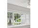 Large window offering a view of the neighborhood, providing natural light and a pleasant outlook at 18504 Putters Pl, Tampa, FL 33647