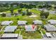 Aerial view of the community, highlighting lush landscaping, a pond, and convenient parking at 1905 Canterbury Ln # 17, Sun City Center, FL 33573