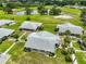 Scenic aerial view of the property, highlighting lush greenery, a pond, and charming residences at 1905 Canterbury Ln # 17, Sun City Center, FL 33573