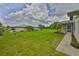 Expansive backyard with lush green lawn, mature trees, and a patio perfect for outdoor entertaining at 1905 Canterbury Ln # 17, Sun City Center, FL 33573
