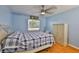 Light blue bedroom with ceiling fan, hardwood floors and window that provides natural light at 1905 Canterbury Ln # 17, Sun City Center, FL 33573