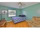 Bedroom features hardwood floors, ceiling fan, and a window that allows for natural light at 1905 Canterbury Ln # 17, Sun City Center, FL 33573