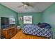 Bedroom features hardwood floors, ceiling fan, window that allows for natural light and TV at 1905 Canterbury Ln # 17, Sun City Center, FL 33573