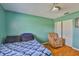 This bedroom has natural light, a closet, a blue quilt, and an accent wall at 1905 Canterbury Ln # 17, Sun City Center, FL 33573