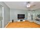 Open living room with wood floors, ceiling fan, and sliding glass doors to the patio at 1905 Canterbury Ln # 17, Sun City Center, FL 33573