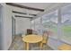 Enclosed patio featuring tile flooring, bright natural light, and wood accents on the ceiling at 1905 Canterbury Ln # 17, Sun City Center, FL 33573