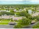 Aerial view of a serene community featuring homes nestled around a peaceful lake and lush green landscape at 200 Gretchen Ct, Oldsmar, FL 34677