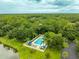 Aerial view of a community pool surrounded by lush trees, providing a refreshing oasis for residents at 200 Gretchen Ct, Oldsmar, FL 34677