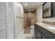 Bathroom features a double vanity, walk-in shower with tile surround, and built in storage at 200 Gretchen Ct, Oldsmar, FL 34677