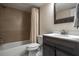 Bathroom features a shower and tub combo with a dark wood vanity and bronze fixtures at 200 Gretchen Ct, Oldsmar, FL 34677