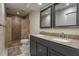 Bathroom with double sink vanity, granite countertop, and tiled walk-in shower at 200 Gretchen Ct, Oldsmar, FL 34677