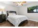 Cozy bedroom features wood floors, fan and a window overlooking the yard at 200 Gretchen Ct, Oldsmar, FL 34677