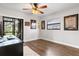 This bedroom has hard wood floors, a window, desk and several wall decorations at 200 Gretchen Ct, Oldsmar, FL 34677