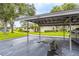 A convenient carport offers covered parking with easy access to the charming homes amidst lush landscaping at 200 Gretchen Ct, Oldsmar, FL 34677