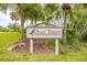 Welcome to Quail Forest: A charming community featuring lush greenery and a welcoming entrance sign at 200 Gretchen Ct, Oldsmar, FL 34677