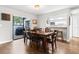 Dining room features hardwood floors, table with seating for six, and access to the patio at 200 Gretchen Ct, Oldsmar, FL 34677