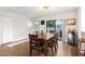 Inviting dining room features a modern light fixture and sliding door to backyard at 200 Gretchen Ct, Oldsmar, FL 34677