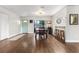 Open concept dining room with hardwood floors and adjacent breakfast bar seating at 200 Gretchen Ct, Oldsmar, FL 34677