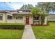 Quaint front exterior of the house with decorative plantings and a well-kept lawn at 200 Gretchen Ct, Oldsmar, FL 34677