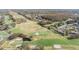 Aerial view of a scenic golf course with ponds, sand traps, manicured greens, and residential area at 200 Gretchen Ct, Oldsmar, FL 34677