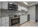 Modern kitchen featuring stainless steel appliances, stylish backsplash, and granite counters at 200 Gretchen Ct, Oldsmar, FL 34677
