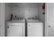 A simple laundry room with a washer and dryer and one wire shelf for storage at 200 Gretchen Ct, Oldsmar, FL 34677