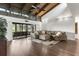 Spacious living room featuring vaulted ceilings, hardwood floors, and plush sectional sofa at 200 Gretchen Ct, Oldsmar, FL 34677