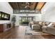 Bright living room features vaulted ceilings, hardwood floors, flat screen television, and sectional sofa at 200 Gretchen Ct, Oldsmar, FL 34677