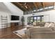 Living room boasts vaulted ceilings, hardwood floors, flat screen television, and sectional sofa at 200 Gretchen Ct, Oldsmar, FL 34677