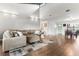 Cozy living room with hardwood floors, plush sectional sofa, and open access to the dining area at 200 Gretchen Ct, Oldsmar, FL 34677