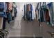 A simple white walk-in closet with clothing hung on wire shelving at 200 Gretchen Ct, Oldsmar, FL 34677
