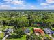 Drone shot shows the property with a pool surrounded by lush greenery at 210 Lake Hobbs Rd, Lutz, FL 33548