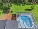 Aerial view of pool and yard. Screen enclosed pool at 210 Lake Hobbs Rd, Lutz, FL 33548