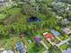 Aerial view of the property and its surroundings, including a pond at 210 Lake Hobbs Rd, Lutz, FL 33548