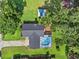 Aerial view of the home with a swimming pool and screened enclosure at 210 Lake Hobbs Rd, Lutz, FL 33548