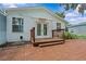 Charming backyard with a wooden deck, brick patio and lush landscaping at 210 Lake Hobbs Rd, Lutz, FL 33548
