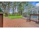 Expansive backyard featuring a deck, patio, and a screened-in pool area at 210 Lake Hobbs Rd, Lutz, FL 33548