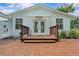 Charming backyard with a wooden deck, brick patio and lush landscaping at 210 Lake Hobbs Rd, Lutz, FL 33548