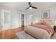 Bright bedroom with wooden flooring featuring closet and attached bathroom at 210 Lake Hobbs Rd, Lutz, FL 33548
